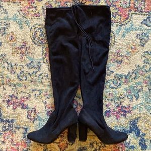 Thigh high black suede heeled boots